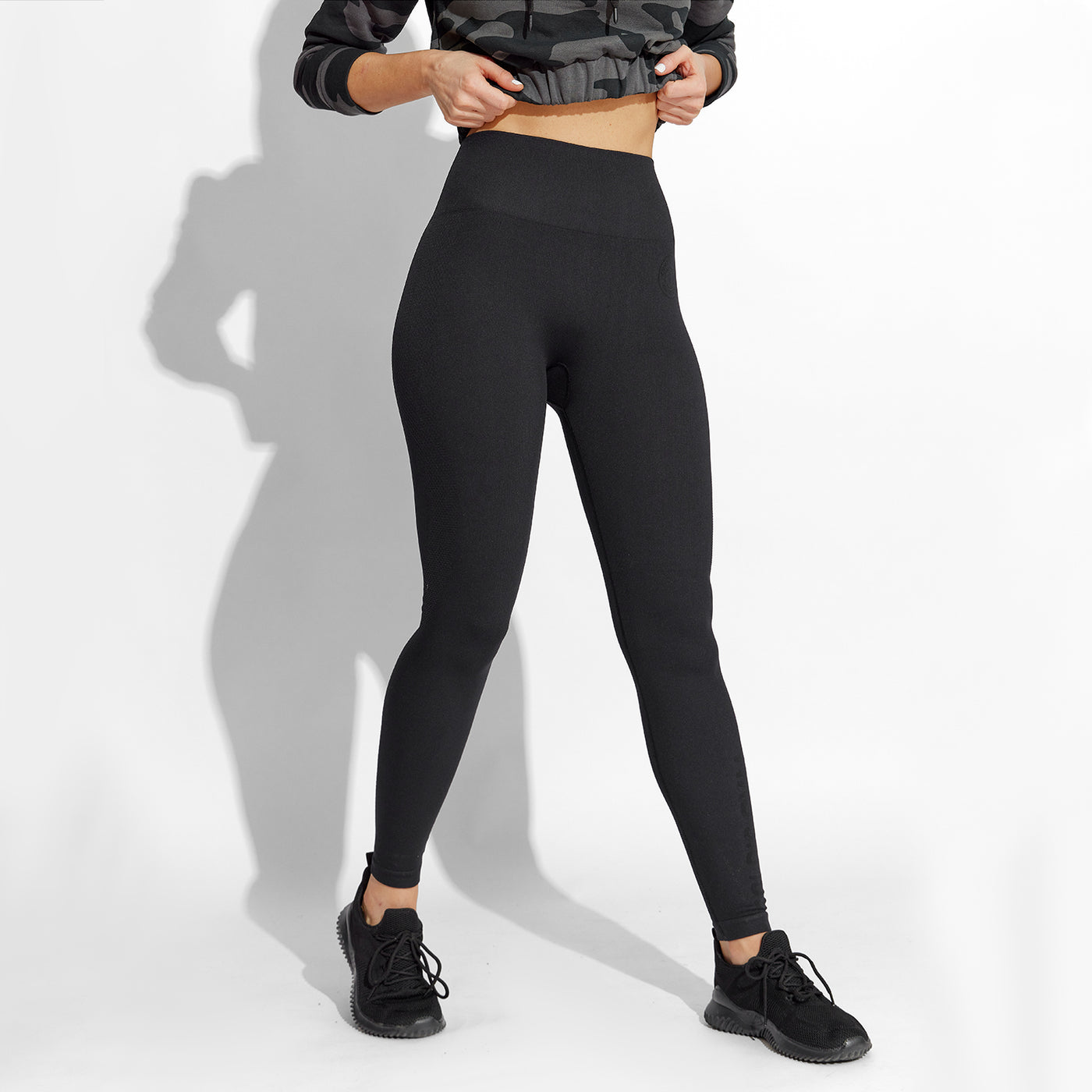 photo of female model wearing train seamless legging in black.