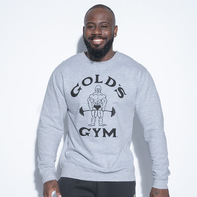 photo of male model wearing classic joe sweatshirt in grey. classic joe logo in center in black with golds gym in black surrounding.