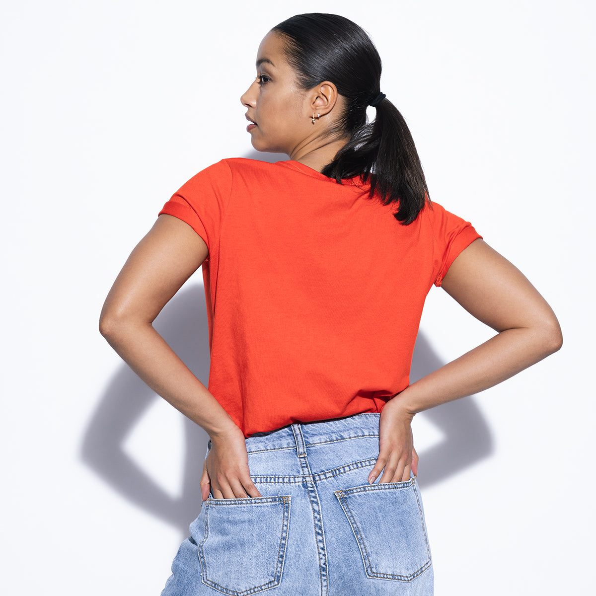 rear photo of female model wearing weight plate tee in red.