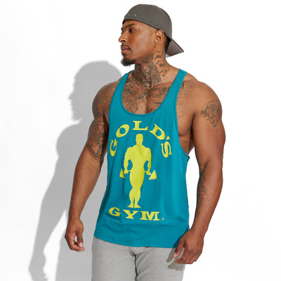 photo of male model wearing train stringer tank in blue. large solid muscle joe logo on front in yellow. golds gym surrounding also in yellow.